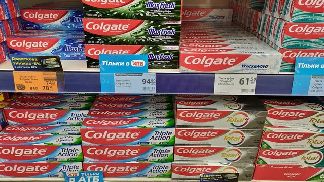 Variety of colgate toothpaste on store shelf. concept of oral hygiene, tooth care, diverse products