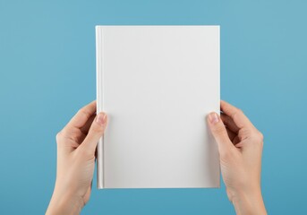 Hands holding blank book mock
