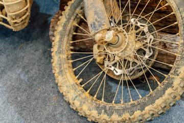 dirty off-road enduro motorcycle wheel. dirt motorcycle tire from off-road racing