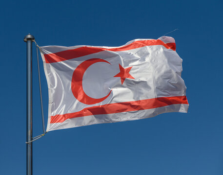Waving proudly in the clear sky, the flag of Northern Cyprus symbolizes heritage and unity on a sunny day
