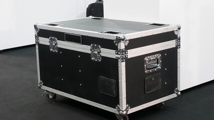 a large black flight case with reinforced metal edges and corner protectors.