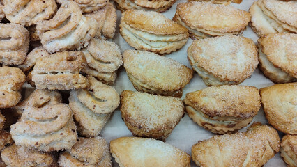 Close-up of assorted baked pastries with sugar topping. concept of sweet indulgence, homemade delicacies, bakery treats.