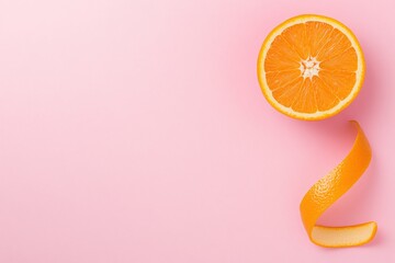 Pink background with orange half, Zesty peel creating spiral accent, Minimal color splash highlighting freshness, Copy space for creative marketing texts, Ideal for vibrant citrus concepts

