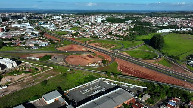 High-angle aerial view of highway infrastructure development. Construction of the access road to Shopping Botucatu, on the Teacher Joao Hipolito Martins Highway (SP-209). 12-24-2024