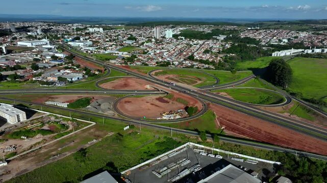 High-angle aerial view of highway infrastructure development. Construction of the access road to Shopping Botucatu, on the Teacher Joao Hipolito Martins Highway (SP-209). 12-24-2024