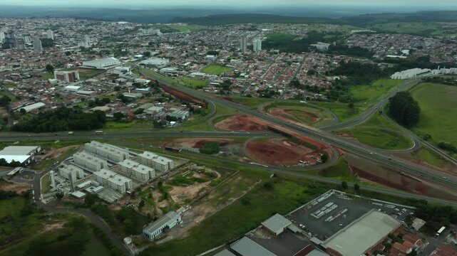 High-angle aerial view of highway infrastructure development. Construction of the access road to Shopping Botucatu, on the Teacher Joao Hipolito Martins Highway (SP-209). 01-16-2025