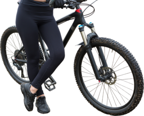 Girl on a mountain bike on offroad, beautiful portrait of a cyclist in rainy weather, Fitness girl rides a modern carbon fiber mountain bike in sportswear. Close-up portrait of a girl in red bandana.
