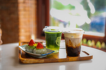 green tea moji daifuku sweets in plate with ice cofee and ice matcha green tea on table at cafe