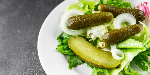 Pickle salad gherkins pickled cucumbers mixed green leaf lettuce appetizer vegetables dish organic fresh tasty gourmet food background on the table food top view copy space vegetarian vegan food
