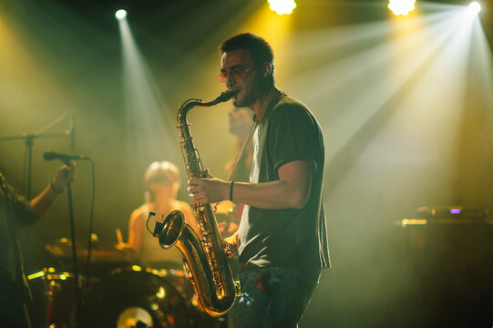 Saxophonist performing live on stage with band