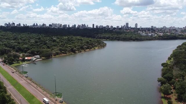 Drone image in motion on a slightly sunny day, with a general view of the lake in Cascavel, a city in the western region of Paran&aacute; (Brazil).

