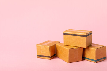 Online shopping concept.Cardboard box and shopping bags in a trolley on a bright colored background. Shopping basket. Online shopping using a laptop, tablet, phone and credit card. Home delivery.