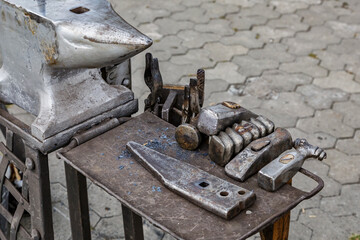 Blacksmith tools on the outdoors.Hand anvil. hummers all blacksmith tools in forge.