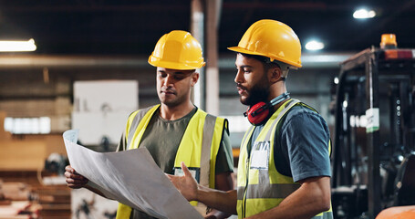 Men, carpenter and blueprint at factory, discussion and review material order for construction project. People, team and paperwork for floor plan, design and supplier for wood at industrial warehouse