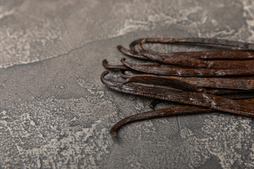 Vanilla pods on a textured background. Vanilla flowers and seeds. vanilla stick bean. Aromatic...