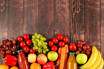 Grapes, oranges, tomatoes, apples, bananas, peppers and natural juice on wooden background, detox diet and weight loss concept, healthy vegan products for a healthy lifestyle, store advertisement