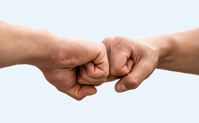 Mans are fist bumping. Fist bump. Clash of two fists, vs. Gesture of giving respect or approval. Friends greeting. Teamwork and friendship. Partnership concept