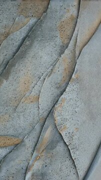 Abstract gray material background with diagonal line patterns and subtle brown spots creates visual interest.