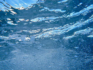 Underwater adventure in clear seawater while sea diving during sunny daylight hours, showcasing vibrant marine life and shimmering waves