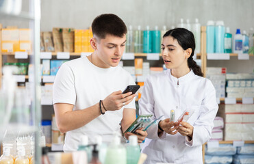 Man scans QR code on toothbrush label. Female pharmacist offers to choose the right toothbrush