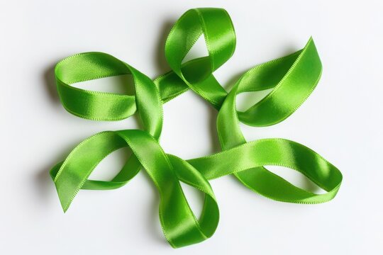 A green ribbon arranged in a circular pattern isolated on white background