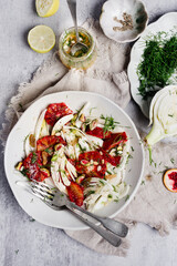 Fresh Fennel blood orange salad served in a plate with dill leaves and salad dressing. healthy...