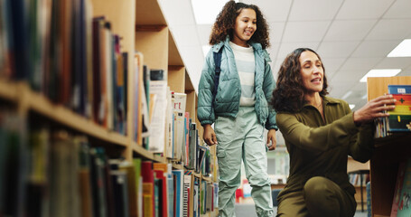 Girl, woman and search for book at library by shelf with smile for learning, help and education. People, child and librarian with guide, language and literature for development, story and scholarship © BuyOutFelix01/peopleimages.com
