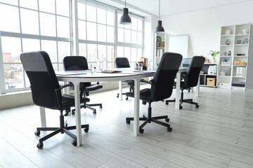 Interior of modern office with table prepared for meeting