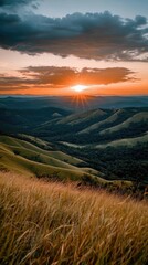 Fototapeta premium Stunning sunset over rolling hills and valleys with dramatic sky and lush greenery