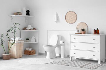 Interior of modern bathroom with ceramic toilet bowl