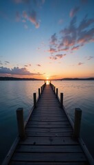 Fototapeta premium Influencer marketing travel concept. A serene sunset over water, with a wooden pier extending into the horizon, reflecting warm colors in the calm surface.