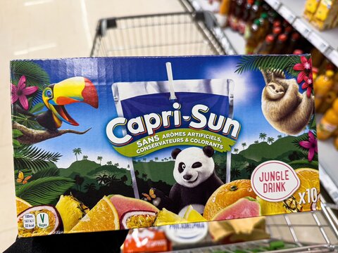 Customer holding capri sun jungle drink multipack in supermarket - FRANKFURT, GERMANY - APRIL 9, 2025
