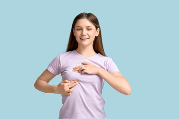 Young woman checking her breast  on blue background