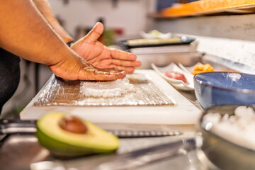 Chef preparing rice for maki sushi in a restaurant kitchen