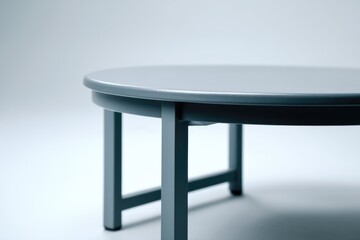 A grey, circular coffee table set against a clean white backdrop, isolated for focus.
