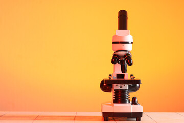 Modern microscope on white tile table