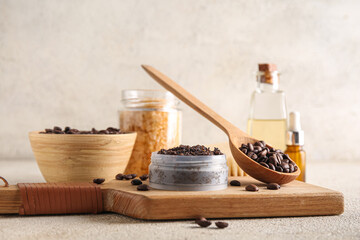 Composition with jar of coffee body scrub, cutting board and coffee beans on light grunge background