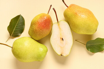 Sweet ripe pears and leaves on yellow background