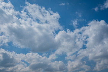white cumulus clouds in blue sky