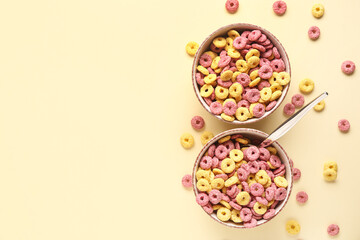 Bowls with cereal rings on beige background