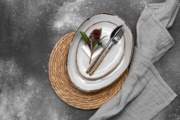 Beautiful table setting with skimmia japonica plant on dark background