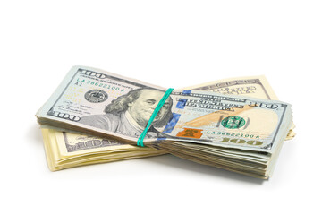 One hundred dollar banknotes tied with rubber bands on white background