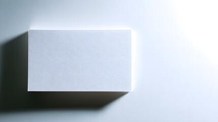 Blank white card on a flat surface, symbolizing simplicity and clarity in design