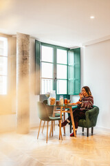 Woman enjoying breakfast in pajamas at home