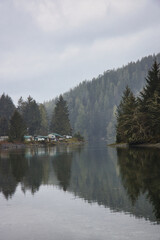 Cabins nestled by a misty lake create a serene getaway scene, vancouver island, british colombia, canada