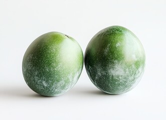Two Fresh Green Fruits on a Light Background Ideal for Healthy Lifestyle, Organic Food, Cooking, and Culinary Arts Imagery for Stock Use