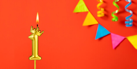 Number 1 birthday candle on an orange background with pennants