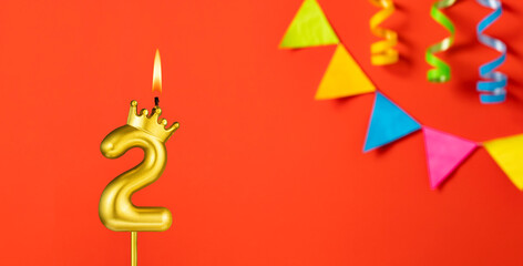 Number 2 candle - Birthday celebration on an orange background with pennants