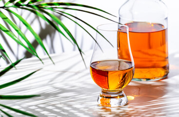 Scotch whisky in glencairn glass for tasting and bottle  n white background