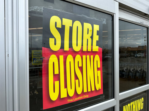 Retail store is going out of business with a large banner displaying store closing sale